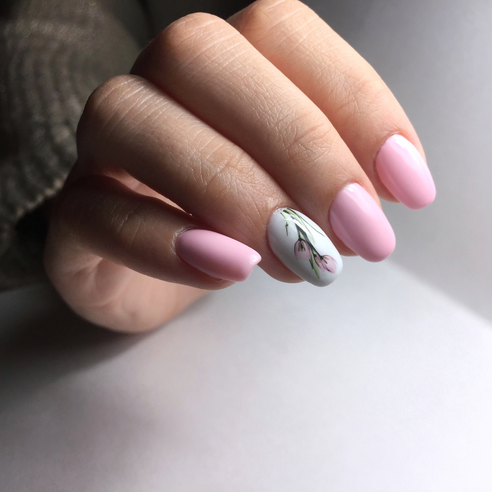 professional pink female manicure on nails close up